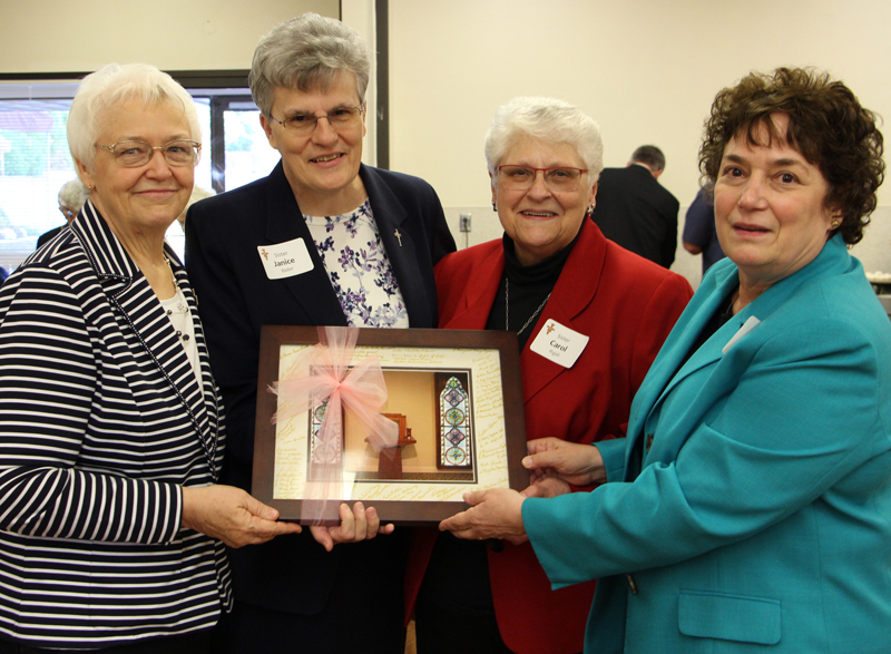 NRRO Executive Director Sister Janice Bader receives photo from the School Sisters of St. Francis&rsquo; U.S. Province leadership team. From left: Sister Marilyn Ketteler, OSF; Sister Janice Bader, CPPS; Sister Carol Rigali, OSF; Sister Deborah Fumagalli, OSF.